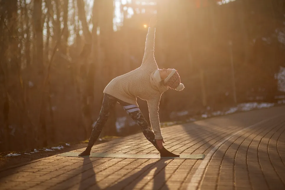 A woman practising yoga outdoors