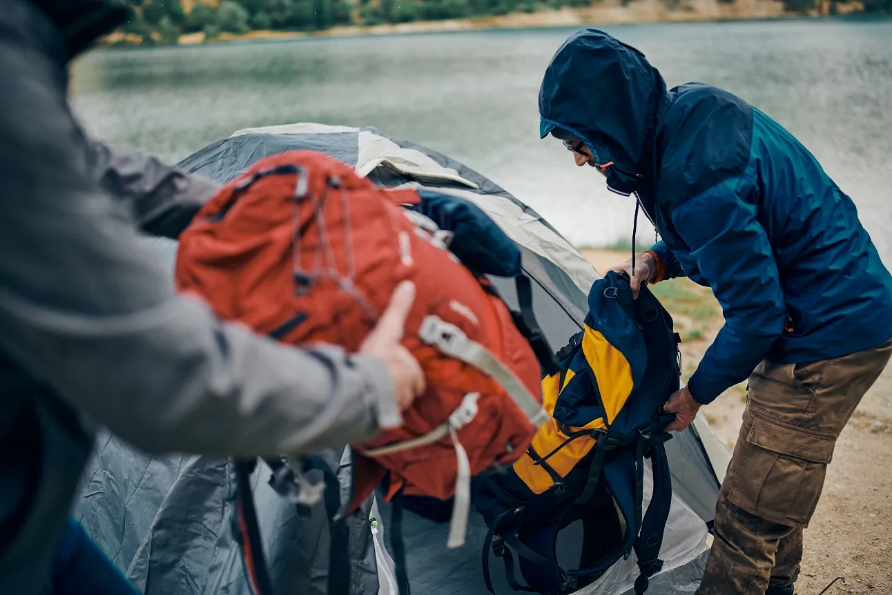 Hikers setting up camp beside a lake