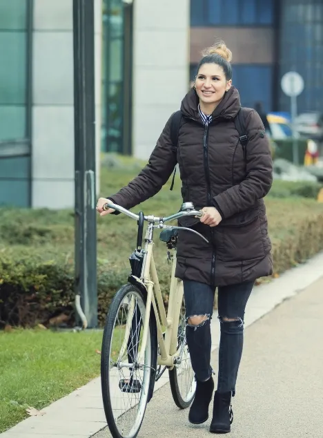 A woman cycling to school