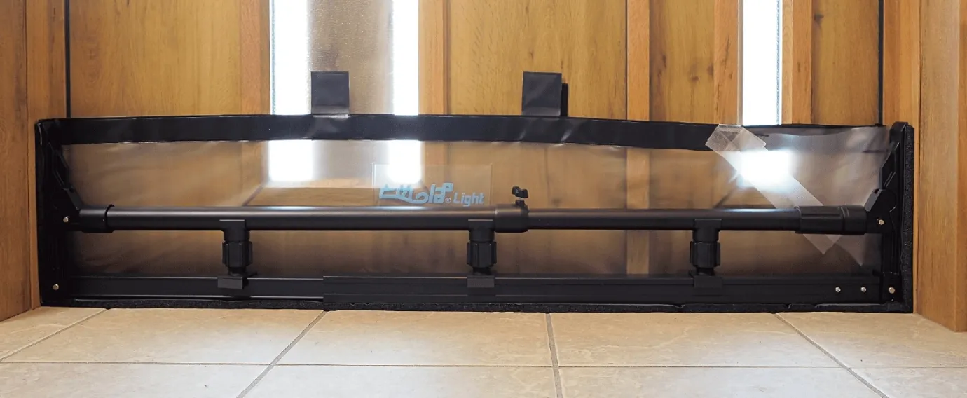 Front view of the installed flood barrier sheet, showing the adjustment pipe and the three jacks
