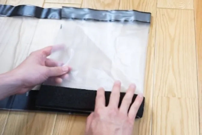 Folding the cut sheet inward from the right end with both hands