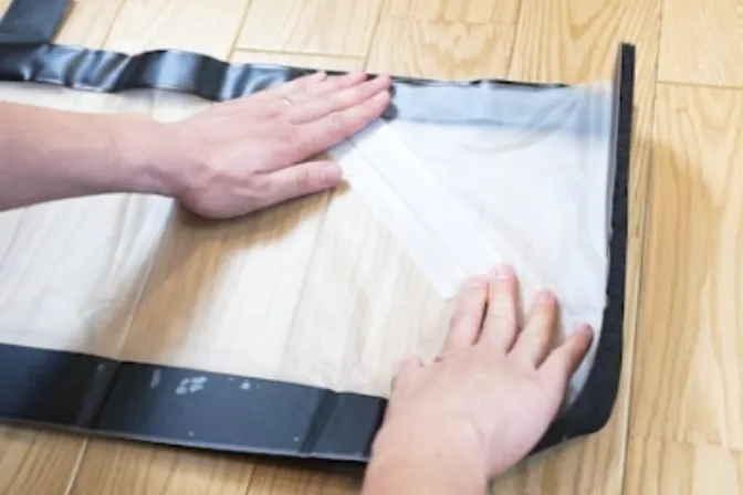 Securing the triangular folded section with curing tape so that it does not open