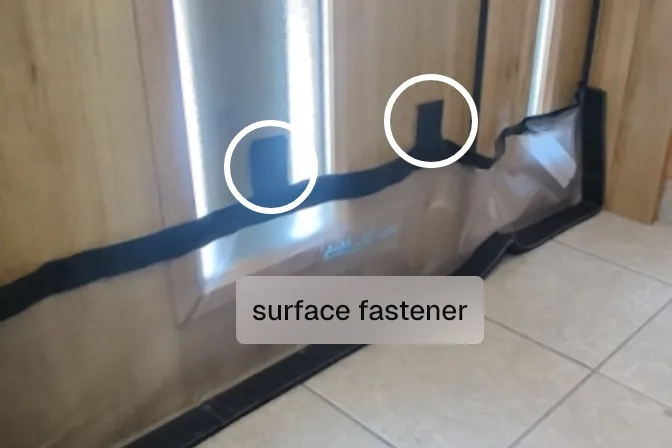 The hook-and-loop surface fasteners on the sheet, circled, being attached to the entrance door