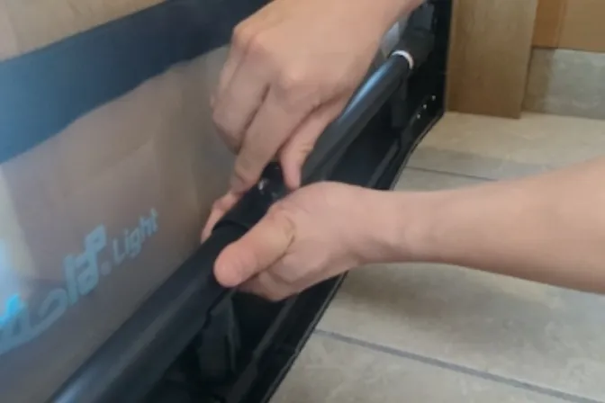 Pulling out the adjustment pipe with both hands to match the width of the opening