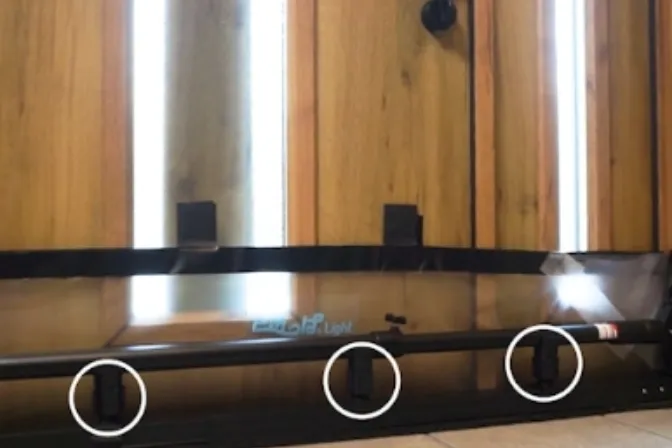The three jacks along the bottom of the unit, circled, being turned to pressurize the floor